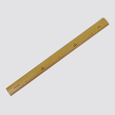 A diagonally placed bamboo ruler.