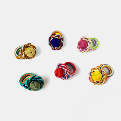 All 6 colors of silk kumihimo aioi rings: (clockwise from top center) navy, pink, yellow, red, green, beige.
