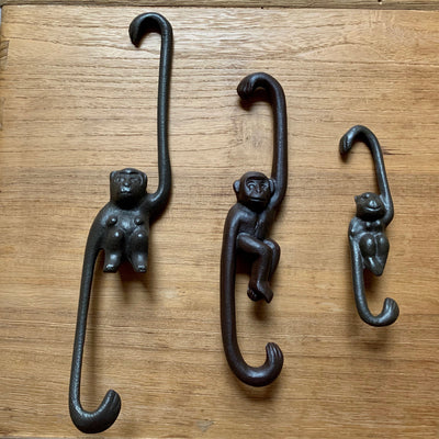 Close-up of cast iron monkey hooks: (from left) large, medium, small.