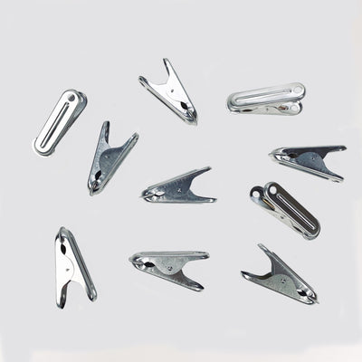 Scattered dolphin aluminum clothespins.