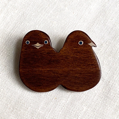 Closeup of a twin chick brooch.