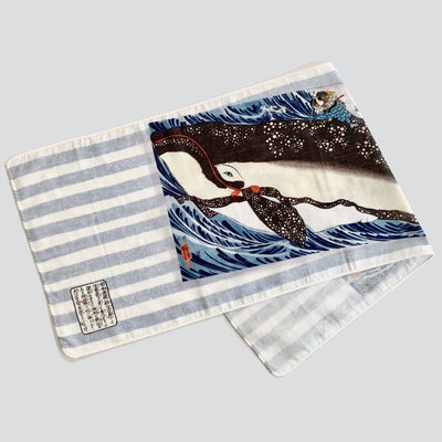 Half folded tenugui with an image of Miyamoto Musashi attacking a giant whale.