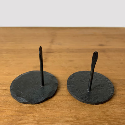 2 styles of round wrought iron mosquito coil holders: hammered edge (left), all over texture (right).