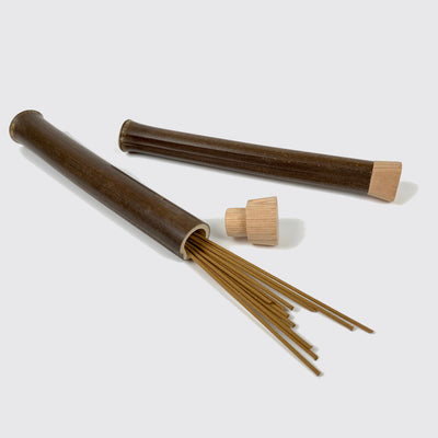Two bamboo incense cases: one with the lid closed and the other with the lid open and incense sticks coming out of the case.