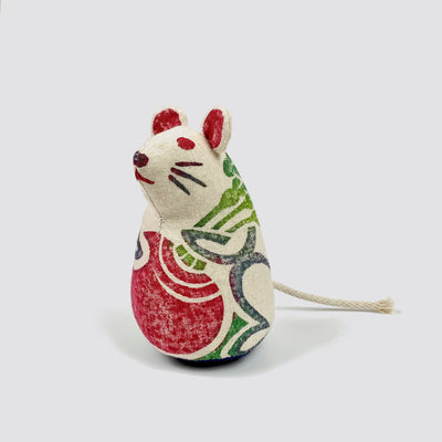 Close up of a woodblock print stuffed mouse.