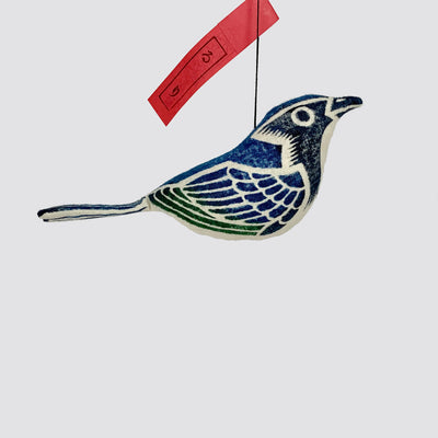 Close up side view of a woodblock print stuffed blue-and-white-flycatcher.