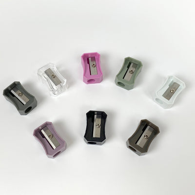 All 8 colors of NJK pencil sharpener No. 516: (top row from left) olive drab, clear, pink, olive, white, (bottom row from left) violet, black, brown.